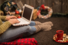 the girl with the computer and with the beautiful Christmas decor and concept holidays